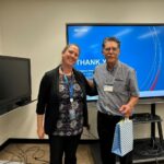 Phil Dregger, right, receives a token of appreciation from Marianne Amerston, director for climate adaptation program at the NRC.