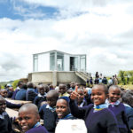 children in front of library