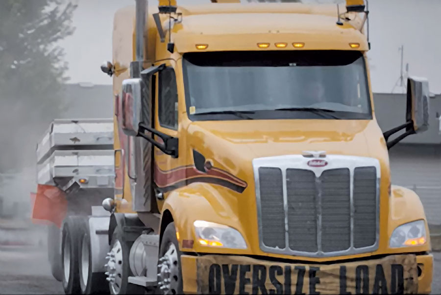 Big yellow truck with composite panels on the back