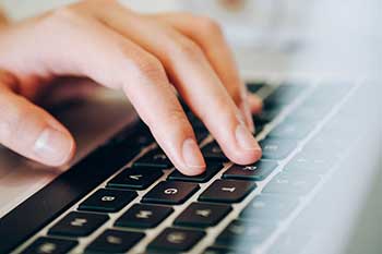 fingers typing on keyboard