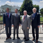 four guys in front of capitol building