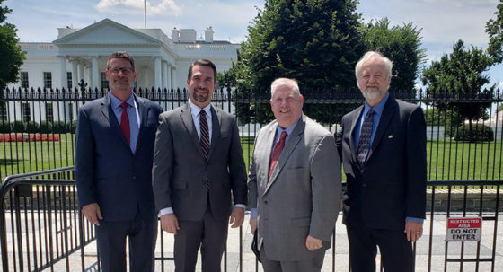 four guys in front of capitol building